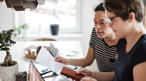 women looking at bills